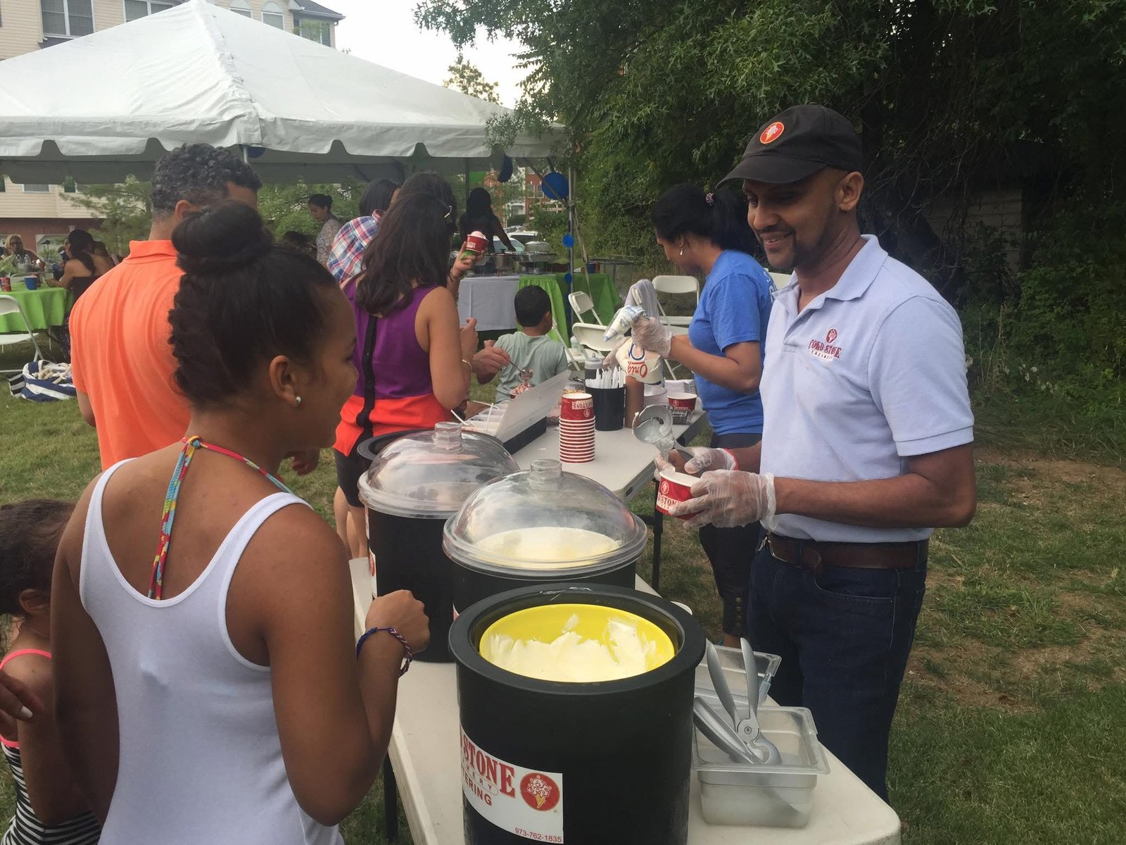 A Cold Stone sundae bar serving guests at an outdoor event