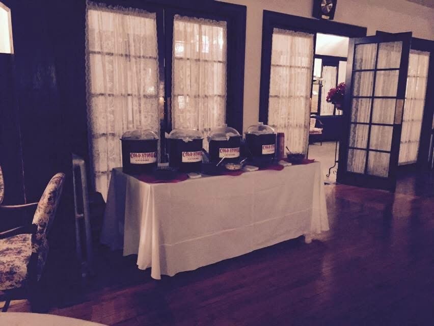 Cold Stone catering tubs on draped tables set up at an event